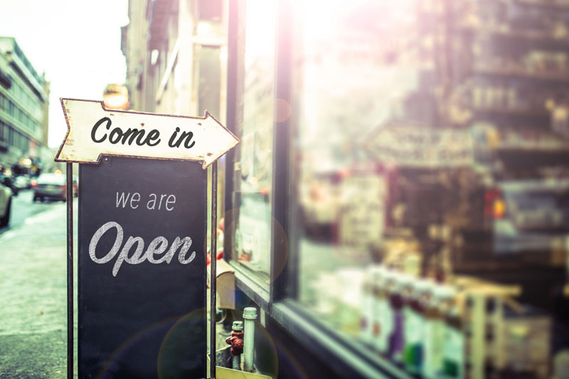 A We Are Open sign in front of a newly opened business that received commercial credit and financing services