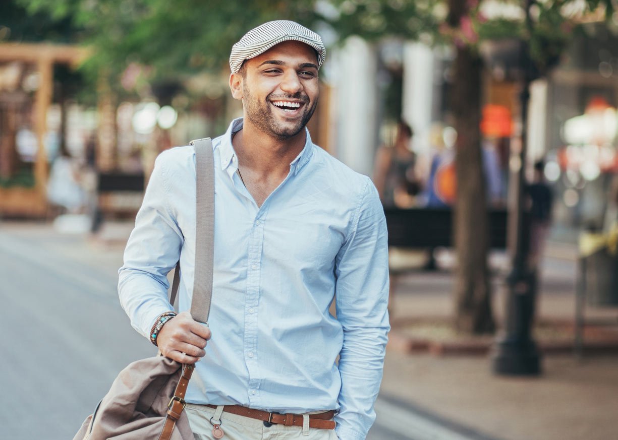A young man walking and smiling thinking aboutIntegrate Private Bank
 loans, deposits, and charitable giving statistics
